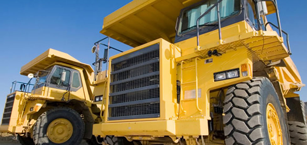 Two big yellow dump trucks