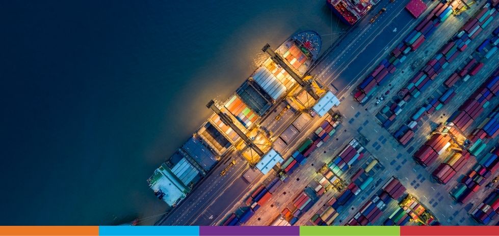 Aerial view of a container ship offloading it's containers at a port at night