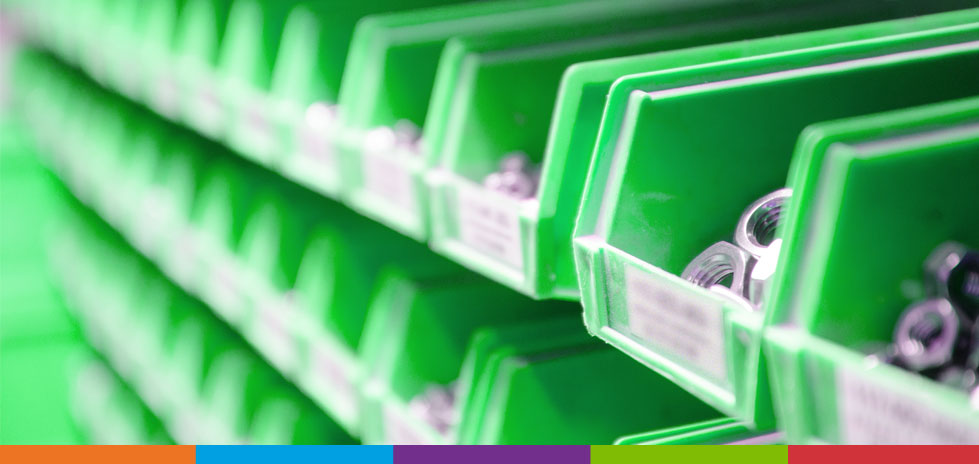 Row of green bins with bolts, nuts and screws in them for inventory management