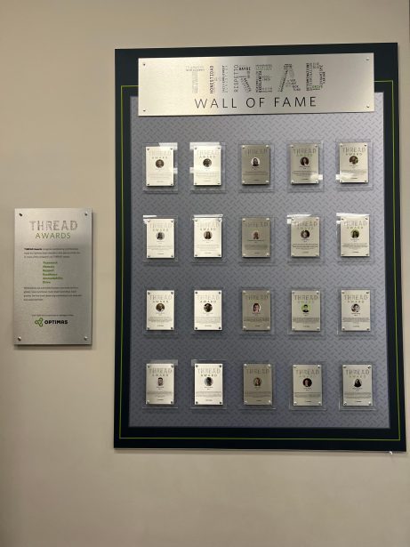 Plaques of THREAD award winners on a wall